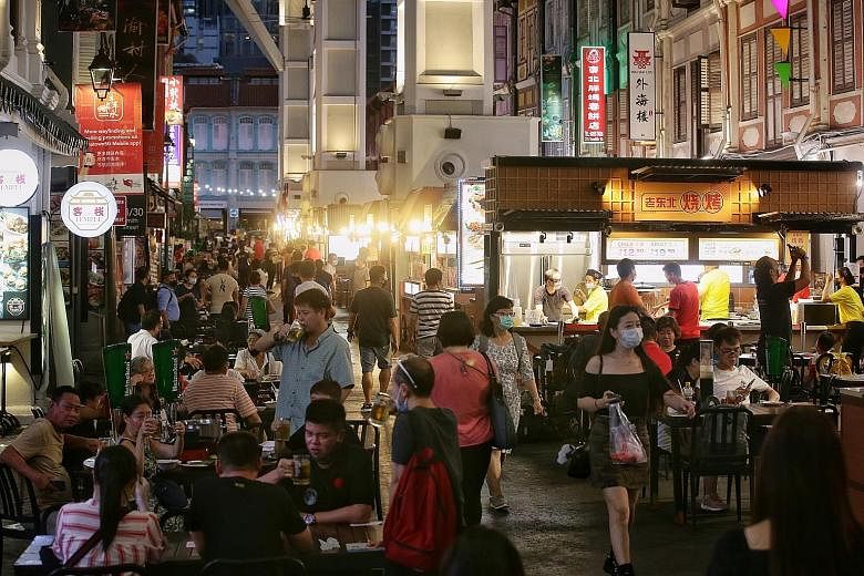 Customers at Chinatown Food Street yesterday. The heritage food and dining spot fully reopened with the introduction of six new steamboat and BBQ a la carte buffet concepts for dinner among 17 stalls lining the street. The venue was closed between Ap