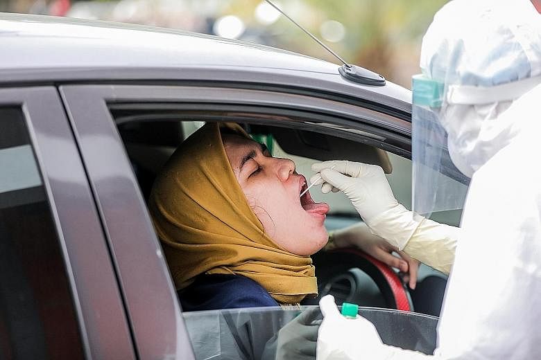 A healthcare worker collecting specimen samples at a Covid-19 test facility in Medan yesterday. Indonesia has the highest number of Covid-19 cases in South-east Asia. Jakarta Governor Anies Baswedan said he will self-isolate at his official residence