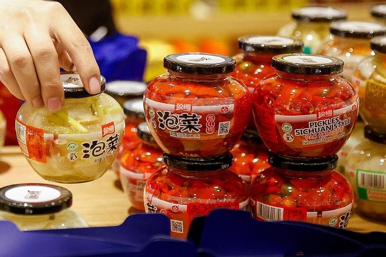 Left: Jars of different types of Chinese-style pickled vegetables, or pao cai, at a supermarket in Beijing. Below: Friends making kimchi in a family home in the eastern port city of Donghae in South Korea. Netizens of both countries are getting hot a