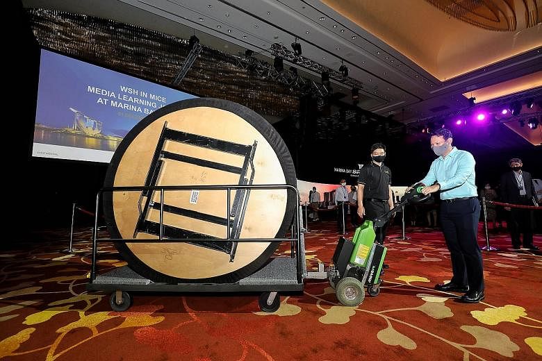 Senior Minister of State for Manpower Zaqy Mohamad trying out a tug machine for moving tables at Sands Expo and Convention Centre yesterday. The venue is preparing for the reopening of Mice events. PHOTO: LIANHE ZAOBAO