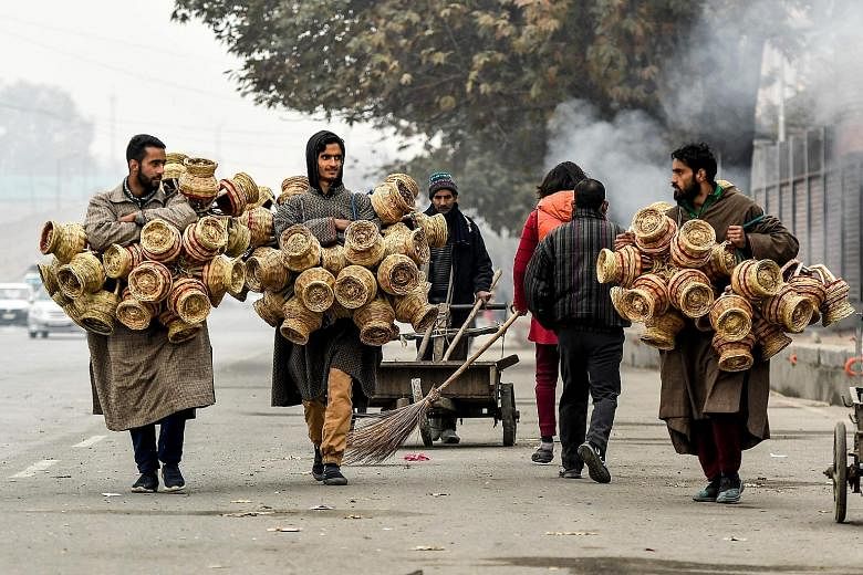 Vendors carrying kangri (earthen pots covered with wicker) in Srinagar last month. The writer dreams of India as a model of religious diversity and harmony, with a vibrant democracy and strong adherence to the rule of law, a country with admirable so