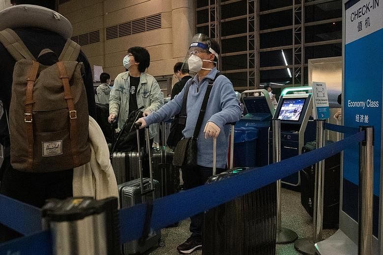 Travellers waiting to check in for a China Southern Airlines flight at Los Angeles International Airport on Nov 23. The Trump administration on Wednesday issued rules to restrict travel to the United States by Chinese Communist Party members and thei