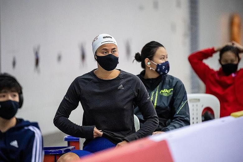 National swimmer Quah Ting Wen (white cap) and other competitors awaiting their turn to race at the Singapore National Olympic Qualifiers yesterday. Covid-19 measures meant the swimmers had to move between allocated areas quickly. PHOTO: SSA