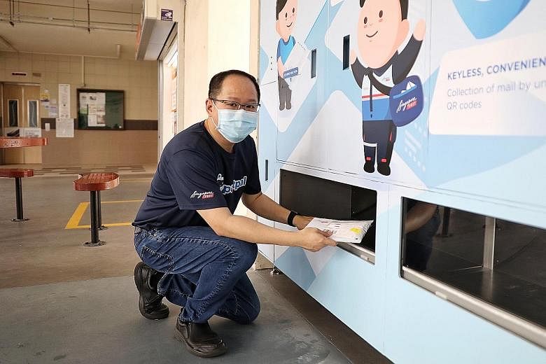 Mr Edmund Tan, vice-president of SingPost's innovation team, demonstrating how to use the PostPal smart letterbox system at its unveiling at Block 202 Clementi Avenue 6 yesterday. Instead of having to sort and slot mail into individual letterboxes, p
