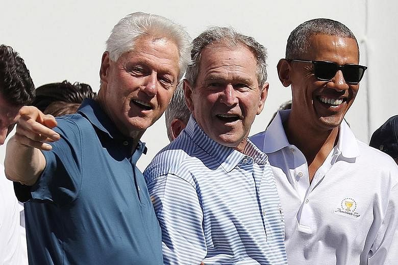A 2017 photo showing former US presidents (from left) Bill Clinton, George W. Bush and Barack Obama at the opening ceremony of the Presidents Cup at Liberty National Golf Club in New Jersey. The three former leaders have said that they would get the 