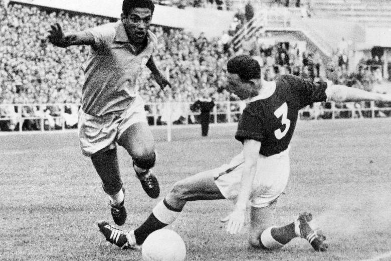 Brazilian forward Garrincha dribbling past Welsh defender Mel Hopkins in the World Cup quarter-final on June 19, 1958 in Gothenburg, Sweden. Brazil advanced to the semi-finals with a 1-0 victory through Pele, then only 17. They also won the final and