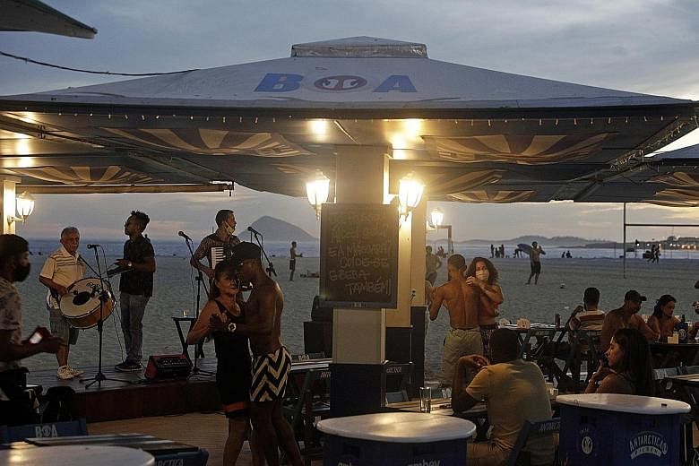 A band playing live music at a bar in Copacabana beach in Rio de Janeiro, Brazil, on Thursday. Easing restrictions in Brazilian cities has led to crowded bars and restaurants.