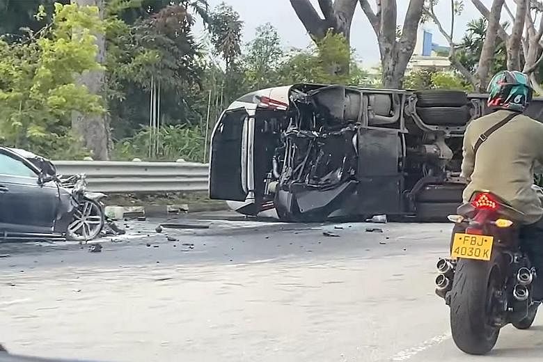 A video screengrab showing a car crushed and a bus lying on its side following their collision yesterday morning on Jurong Island. The driver of the car as well as 21 passengers on the bus were taken to hospital.