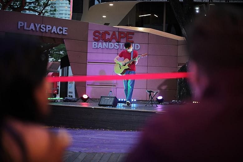 Mr Alan Ang Moncayo performing during a live pilot busking session at *Scape last Saturday. The writer says the act of dropping cash into hats is very much a feature of busking and asks that the practice be kept. ST PHOTO: GIN TAY