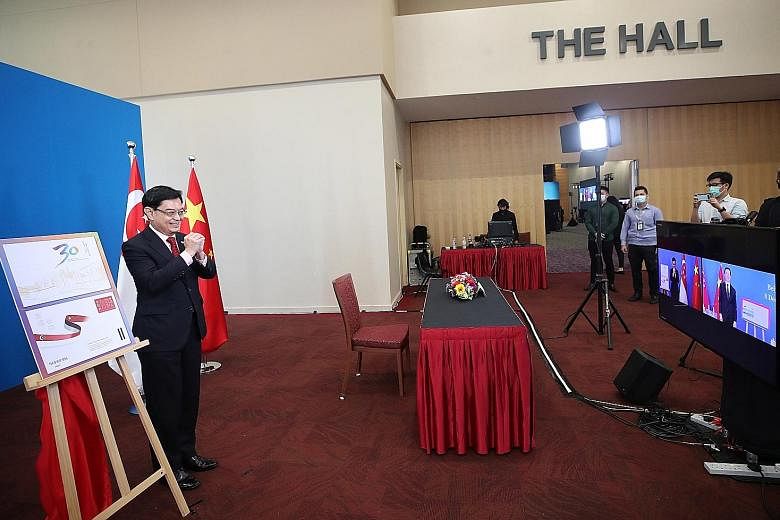 Deputy Prime Minister Heng Swee Keat greeting Chinese Vice-Premier Han Zheng on camera at the 16th Joint Council for Bilateral Cooperation (JCBC) yesterday. The two leaders jointly chair the JCBC, the highest-level bilateral platform between Singapor