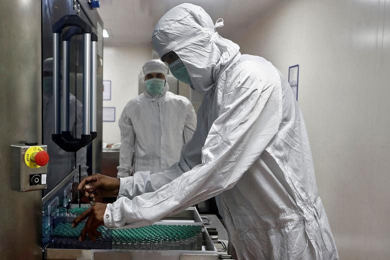 An employee at the Pune-based Serum Institute of India (SII) working on the Oxford University and AstraZeneca vaccine last month. SII is the world's biggest vaccine producer. Of the three vaccine candidates India has booked, SII is manufacturing two 
