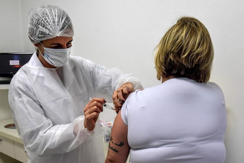 A doctor in Brazil volunteering for a Covid-19 vaccine shot in July. A US study of AstraZeneca's vaccine involving about 30,000 volunteers is in the works and should produce data by late January. PHOTO: AGENCE FRANCE-PRESSE