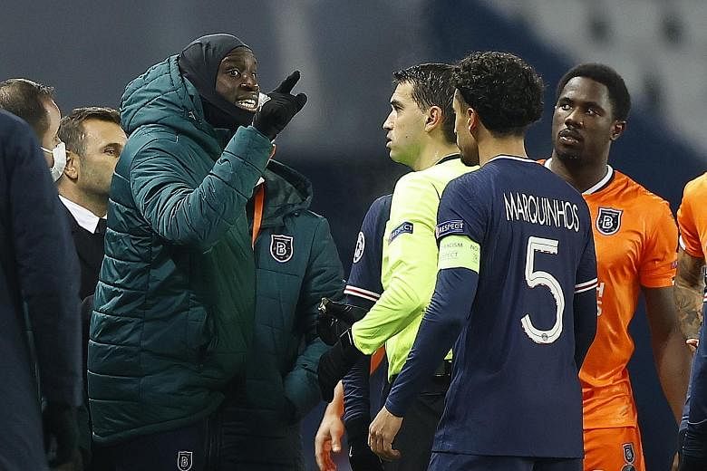 Basaksehir substitute Demba Ba remonstrating with referee Ovidiu Hategan after assistant coach Pierre Webo was allegedly abused by the fourth official in the Champions League game against PSG on Tuesday.