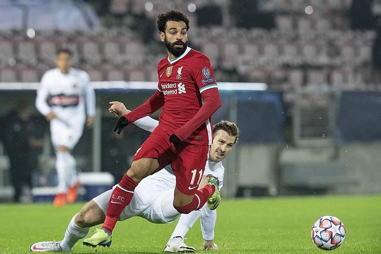 Liverpool's Mohamed Salah battling for the ball with Midtjylland's Erik Sviatchenko in their 1-1 Champions League draw on Wednesday. Salah, who scored for the Reds, has 22 Champions League goals, surpassing former captain Steven Gerrard's tally.