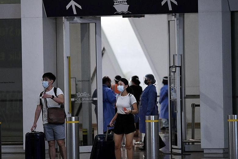Passengers disembarking from the Quantum of the Seas cruise ship at the Marina Bay Cruise Centre on Wednesday. The Singapore Tourism Board described the response to the suspected Covid-19 case as "swift and robust", adding that protocols were validat