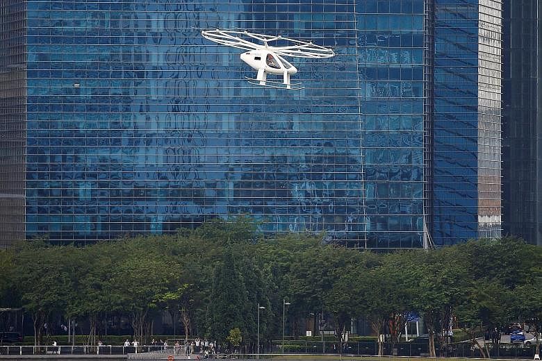 An air taxi from German aviation start-up Volocopter performing a demonstration in Singapore in October last year. The first route the company's emission-free air taxi will take in the Republic will likely be a touristic one over the southern waters,