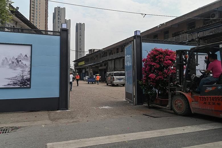The once-bustling Huanan Seafood Wholesale Market in the Chinese city of Wuhan is now walled off, although the eyewear wholesale market on the second floor has reopened for business.