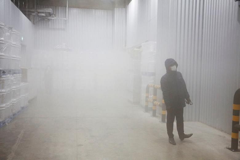 A Korea Superfreeze employee in the company's ultra-cold storage facility in the South Korean city of Pyeongtaek on Thursday. The cold storage logistics firm has been in talks with the Korea Disease Control and Prevention Agency about a contract to s