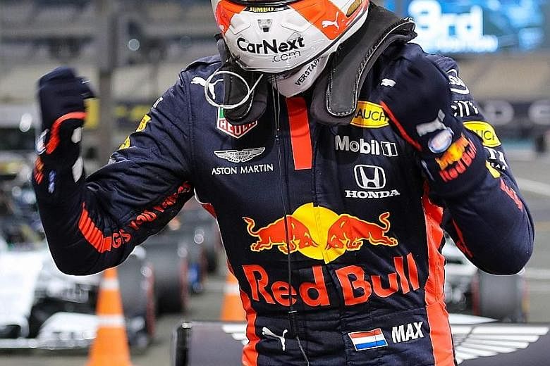Red Bull's Dutch driver Max Verstappen celebrating after securing his third career pole by qualifying top for the Abu Dhabi F1 race at the Yas Marina Circuit.