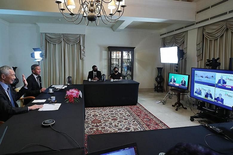 Prime Minister Lee Hsien Loong and Foreign Minister Vivian Balakrishnan attending the Pacific Alliance Summit via video call with the leaders of Chile, Colombia, Mexico and Peru on Friday. PHOTO: MINISTRY OF COMMUNICATIONS AND INFORMATION
