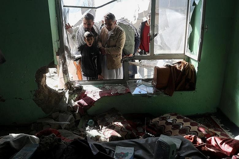 A house damaged by the blast from a rocket attack in Kabul yesterday. At least one person was killed and two injured as 10 rockets hit parts of the Afghan capital, officials said. A Taleban spokesman said his group was not responsible as it continued