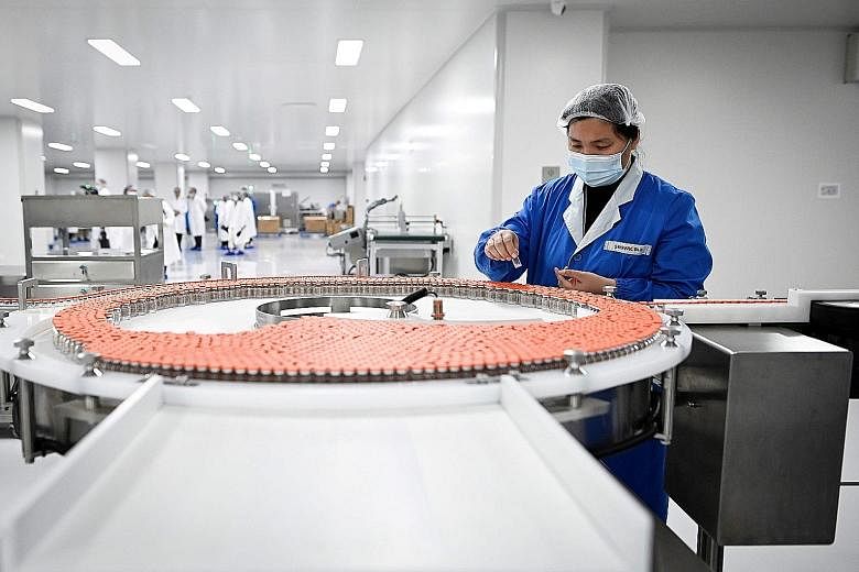 A worker at biopharmaceutical company Sinovac Biotech's Beijing factory in September. About a fifth of all shots listed by the World Health Organisation as undergoing clinical trials are Chinese in origin.