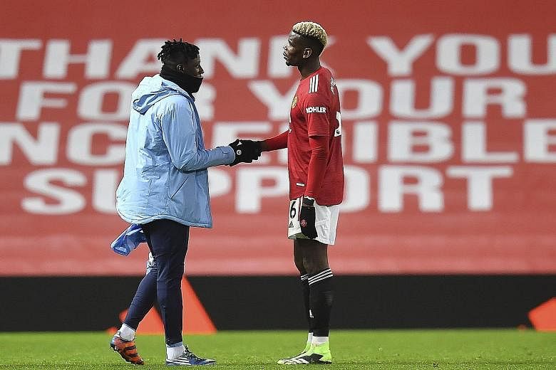 Manchester City's Benjamin Mendy shaking hands with his France teammate Paul Pogba of Manchester United after Saturday's derby. PHOTO: EPA-EFE