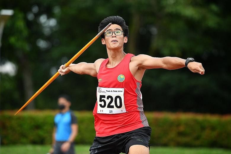 Roy Ng, 17, setting an Under-18 boys' national javelin record with a 61.79m throw at Kallang yesterday. ST PHOTO: CHONG JUN LIANG