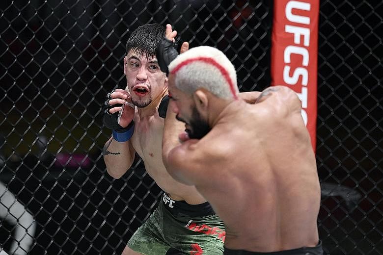 Ultimate Fighting Championship (UFC) flyweight champion Deiveson Figueiredo retained his belt after a majority-draw decision against Brandon Moreno (left) in the main event of UFC 256 on Saturday. Figueiredo (20-1-1) and Moreno (18-5-2) engaged in fi