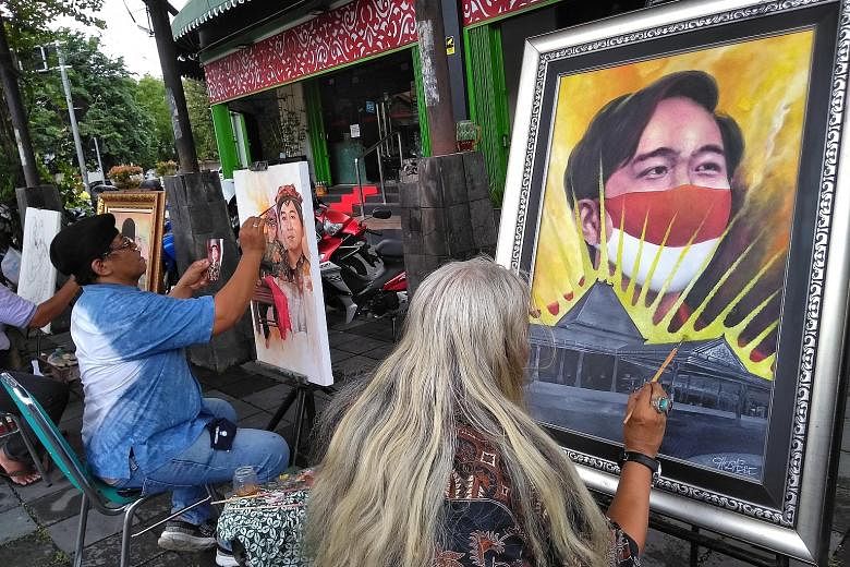 Artists painting portraits of Mr Gibran Rakabuming Raka. Passionate about their culture and heritage, Solo residents hope for a leader who is able to go global without sacrificing local customs and traditions. PHOTO: COURTESY OF ANWAR MUSTAFA