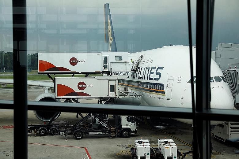 Ground-handler and in-flight caterer Sats restocking a Singapore Airlines plane at Changi Airport in October. The firm was placed first among 100 Singapore publicly listed companies in the 2019 Asean Corporate Governance Scorecard, followed by United