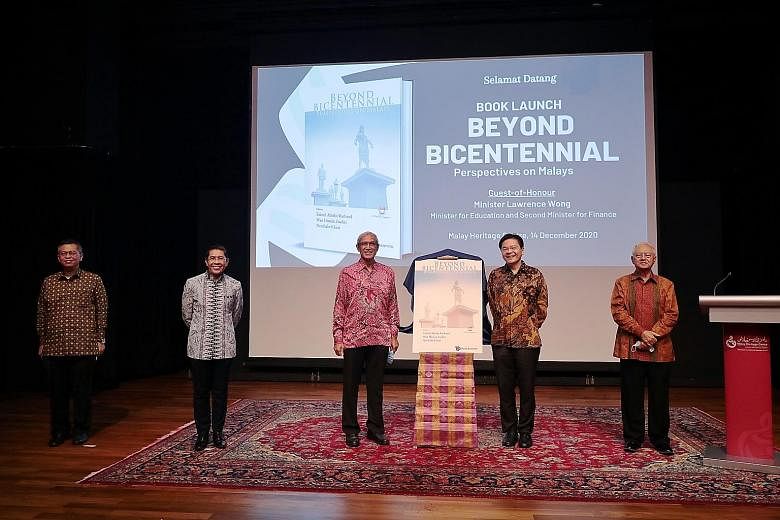 Minister for Education Lawrence Wong at the launch of Beyond Bicentennial: Perspectives On Malays yesterday with Minister in the Prime Minister's Office Maliki Osman (second from left) and the book's co-editors (from left) Norshahril Saat, Zainul Abi