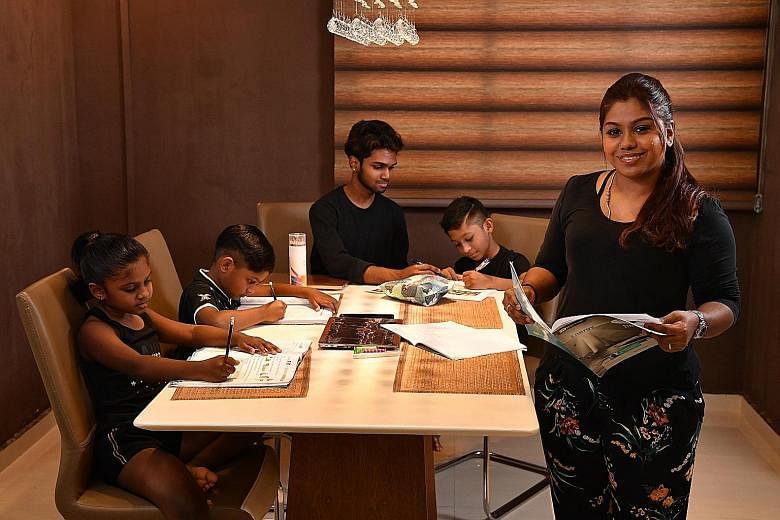 Mrs Kousalya Selvakumar during a study session at home with her children (from left) Davitha, Vinayak, Surendra and Dhanvin. Mrs Kousalya made it to the Director's List at ITE College East every semester and graduated with a Certificate of Merit and 
