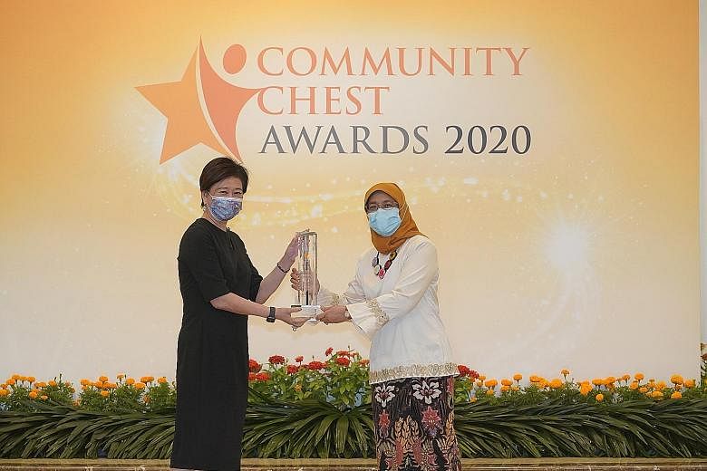 Above: Singtel group chief executive Chua Sock Koong receiving the telco's Pinnacle Award from President Halimah Yacob at the Community Chest Awards ceremony at the Istana last Friday. Left: DBS Singapore country head Shee Tse Koon receiving the bank