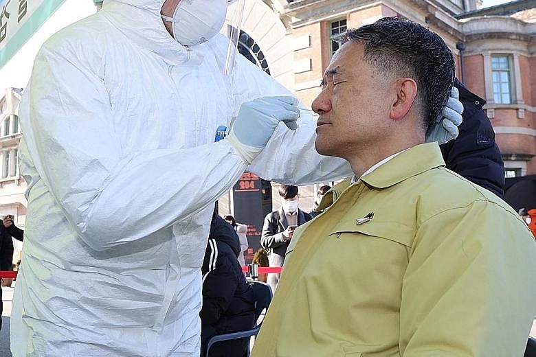 Health Minister Park Neung-hoo undergoing a coronavirus swab test yesterday in Seoul. PHOTO: EPA-EFE