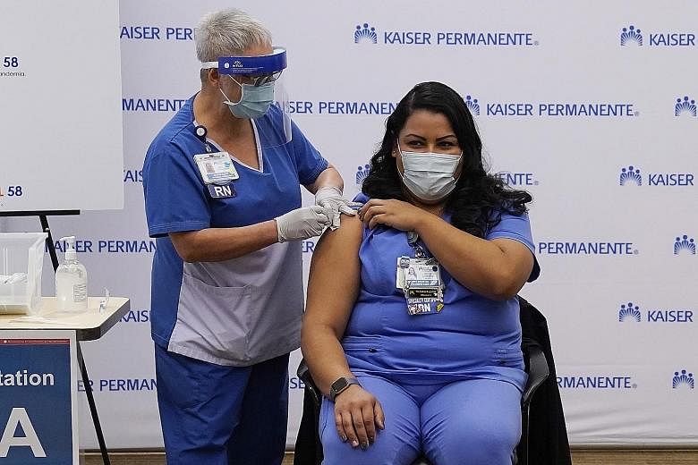 An ICU nurse receiving the Pfizer-BioNTech Covid-19 vaccine in Los Angeles, California, on Monday. Record coronavirus cases have left the county of 10 million people with fewer than 100 ICU beds available.