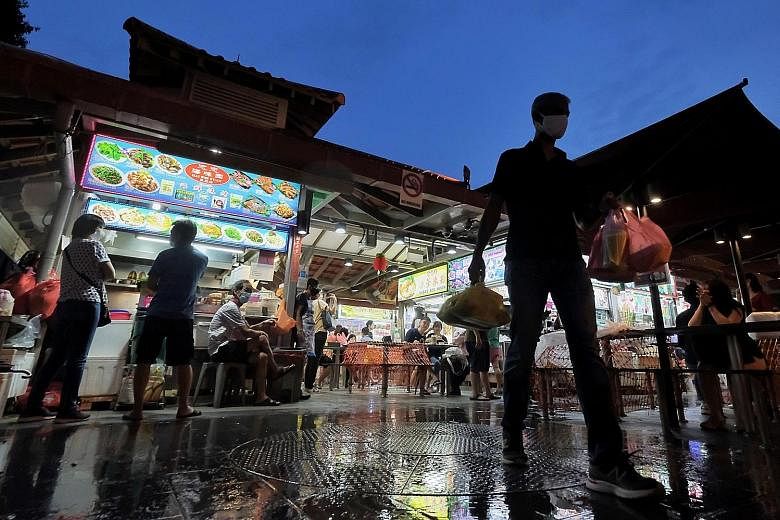 Customers at Chomp Chomp Food Centre in Serangoon Gardens yesterday. The inscription of Singapore's hawker culture on the Unesco intangible heritage list has been anticipated for nearly three years. Singapore Heritage Society president Jack Lee said 