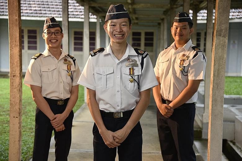 (From left) Evan Lim Shouwang, Kennard Tay Sze Han and Brendan Soh Heng Yi were among seven senior cadet lieutenants who received the President's Award - the highest accolade in the Boys' Brigade - from President Halimah Yacob at the Istana yesterday