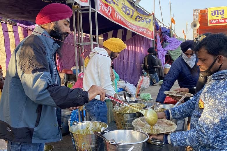 Free meals being distributed on Wednesday at a community kitchen near Delhi's Singhu border with Haryana state, where farmers are protesting against new farm laws.