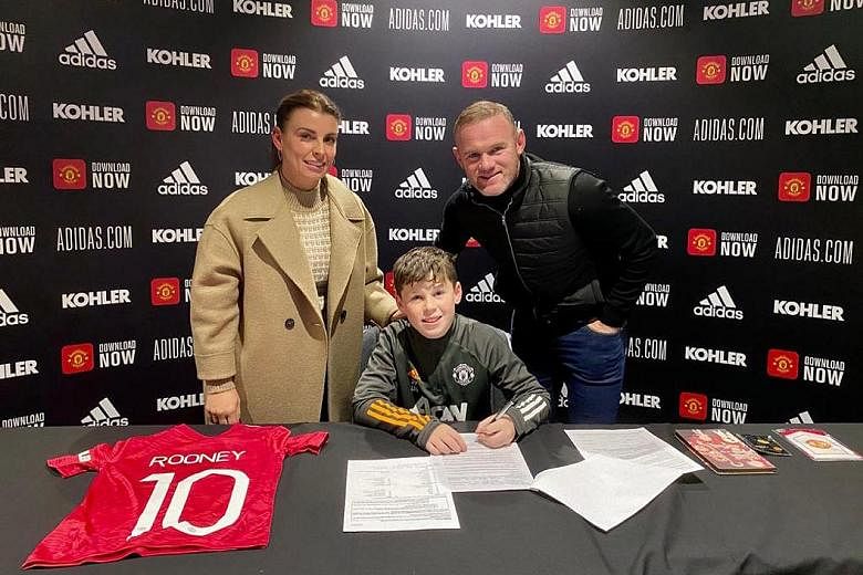 Wayne Rooney and wife Coleen at their eldest son Kai's signing ceremony for Manchester United on Thursday.