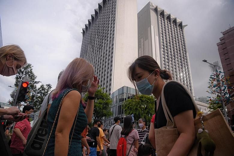 Guests at the Mandarin Orchard Singapore's pick-up point (above) yesterday. Staycations at the hotel (left) in Orchard Road were cut short after the Ministry of Health said it was probing 13 Covid-19 cases among people who had served their stay-home 