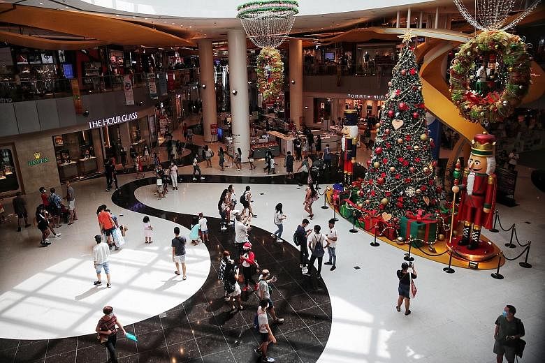Above: Shoppers at West Mall yesterday, on the final weekend before Christmas. ST PHOTO: CHONG JUN LIANG Right: VivoCity on Saturday, where regular announcements reminded people to keep a safe distance. ST PHOTO: GIN TAY Below: Social distancing amba