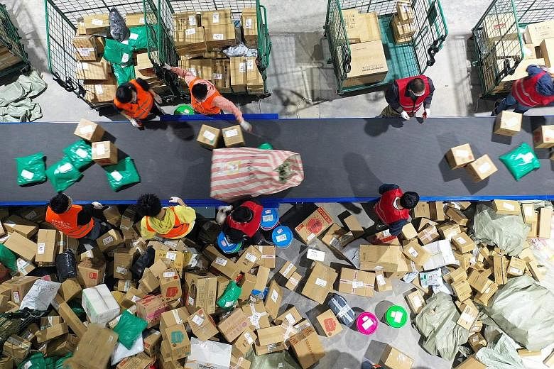 Workers sorting packages for delivery at a warehouse in Hengyang in Hunan province on Nov 12, a day after the annual Singles' Day shopping event. Greenpeace estimates that Singles' Day generated 52,400 tonnes of carbon dioxide from manufacturing, pac