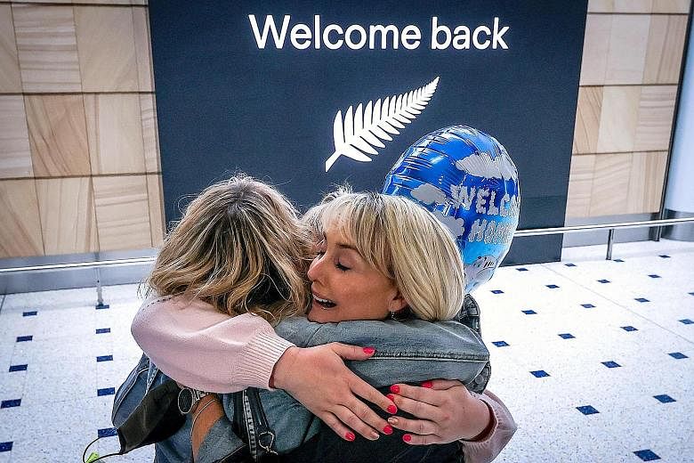 A passenger hugging a family member upon arrival from New Zealand at Sydney Airport in October, after Australia's border rules were relaxed under a new one-way trans-Tasman travel agreement. PHOTO: AGENCE FRANCE-PRESSE Above: SilkAir and Jetstar plan