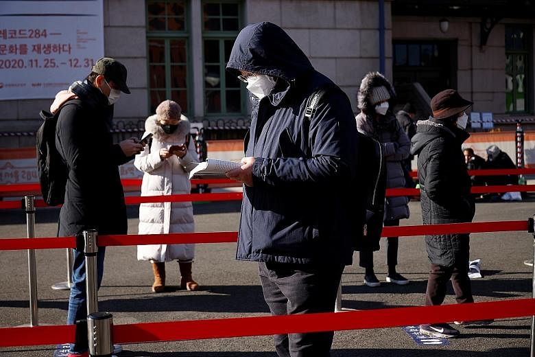 People queueing on Friday at a temporary coronavirus testing site in front of a railway station in Seoul. South Korea posted its second-highest daily number of cases yesterday. The government plans to meet today to discuss whether to tighten distanci