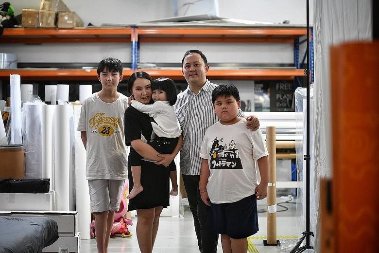 Marketing manager Kenny Cheah, 35, and his self-employed wife Sylvia Chong, 31, with their children Nicholas, 13, Reiko, four, and Devin, eight, at Ms Chong's office in Kaki Bukit. At the end of last month, Reiko was brought over from Johor, where sh