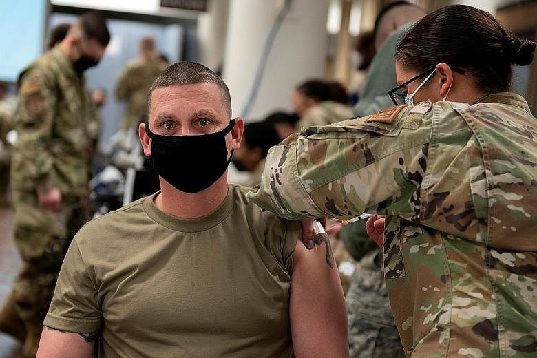 A US Air Force soldier getting a coronavirus vaccine at Osan Air Base in Pyeongtaek, South Korea, yesterday. The majority of South Koreans will get their shots only in February or March when the country's first purchased vaccines - from British-Swedi