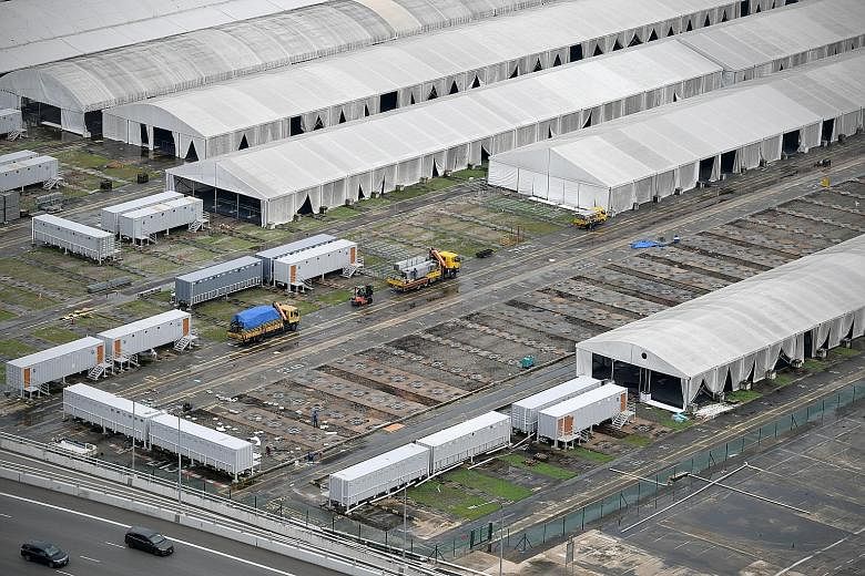 Part of the facilities at Tanjong Pagar Terminal being taken down on Tuesday. The mega-facility was intended to house up to 15,000 patients or foreign workers with Covid-19. Some tentage facilities there will remain operational as the Government cont