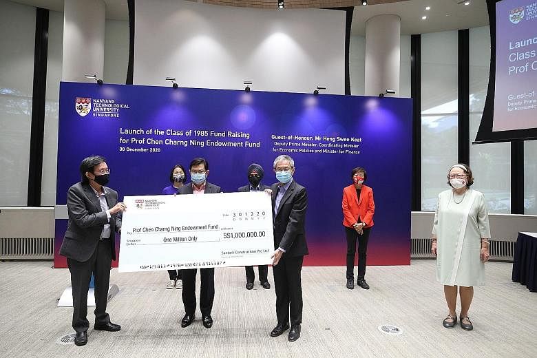 Deputy Prime Minister Heng Swee Keat, flanked by Santarli Construction managing director Lee Boon Teow (left) and NTU deputy president Ling San, with the firm's $1 million cheque to the university's new Professor Chen Charng Ning Endowment Fund yeste