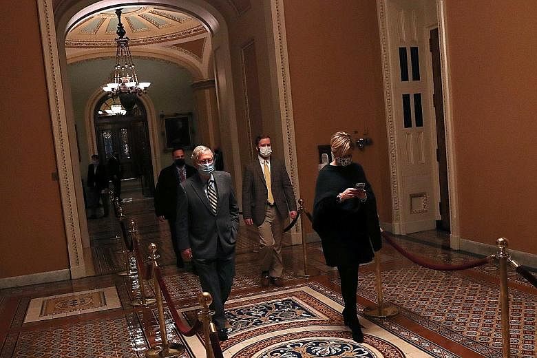 Senate Majority Leader Mitch McConnell (foreground, left) on Wednesday, after declining to schedule a swift Senate vote on a Bill to increase the amount to be given to Americans in relief cheques. Democrats have insisted the aid is for people in dire